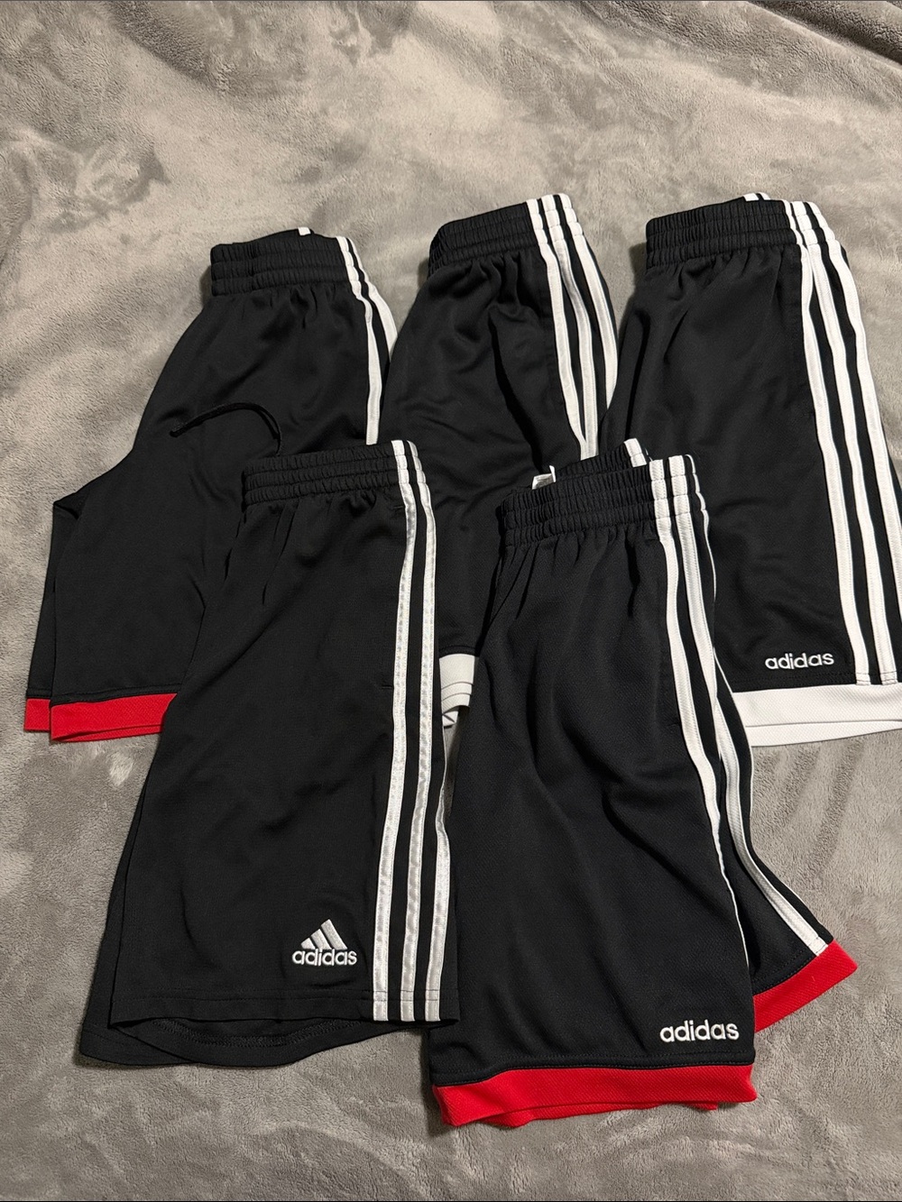 adidas Kids Black Athletic Shorts with White Stripes and Red Hem Accents